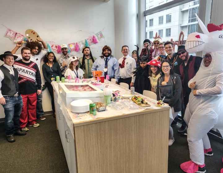 A large group photo of the JHMTIC team dressed in different Halloween costumes
