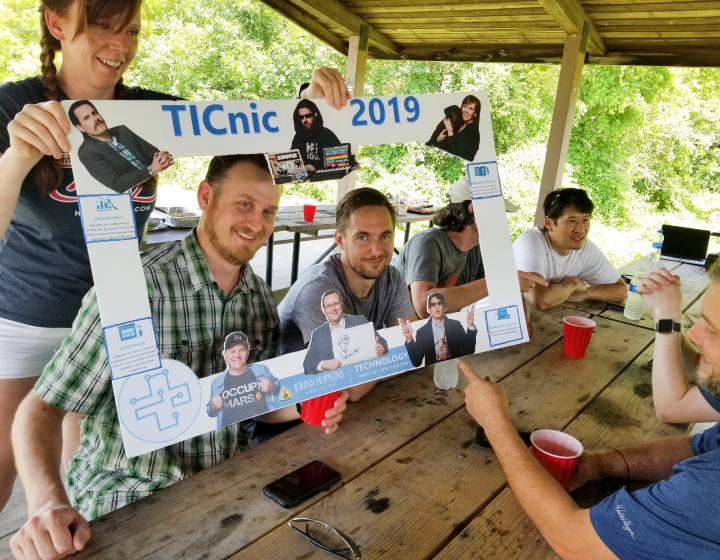 JHMTIC team members in a selfie photo frame during a annual summer picnic